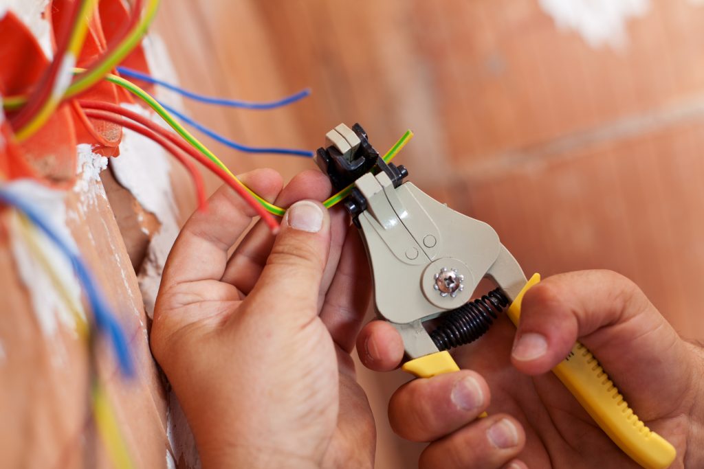 Electrician inspecting electrical wiring