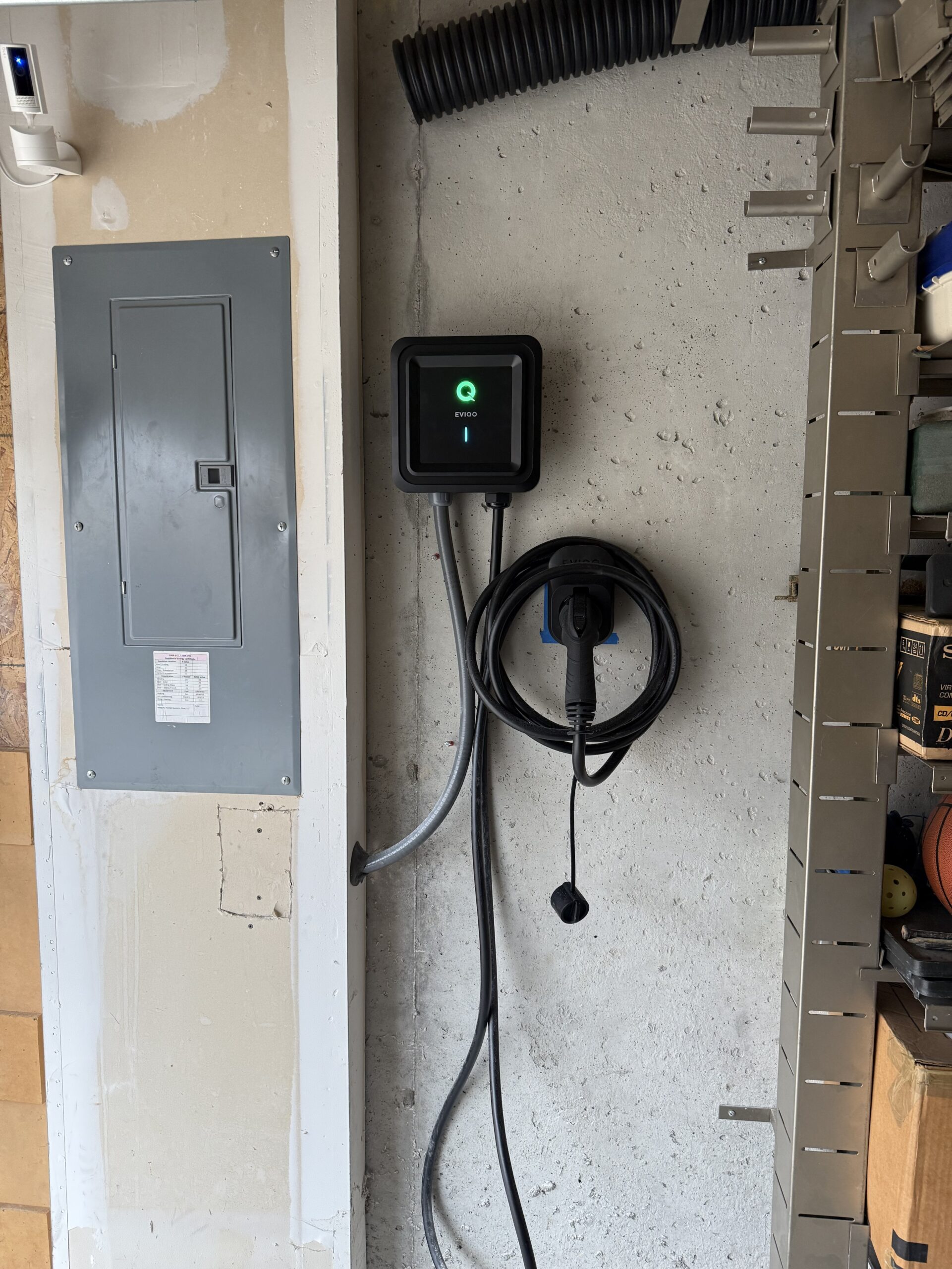 EV charger and electrical panel installation in garage by SparkWise Electric
