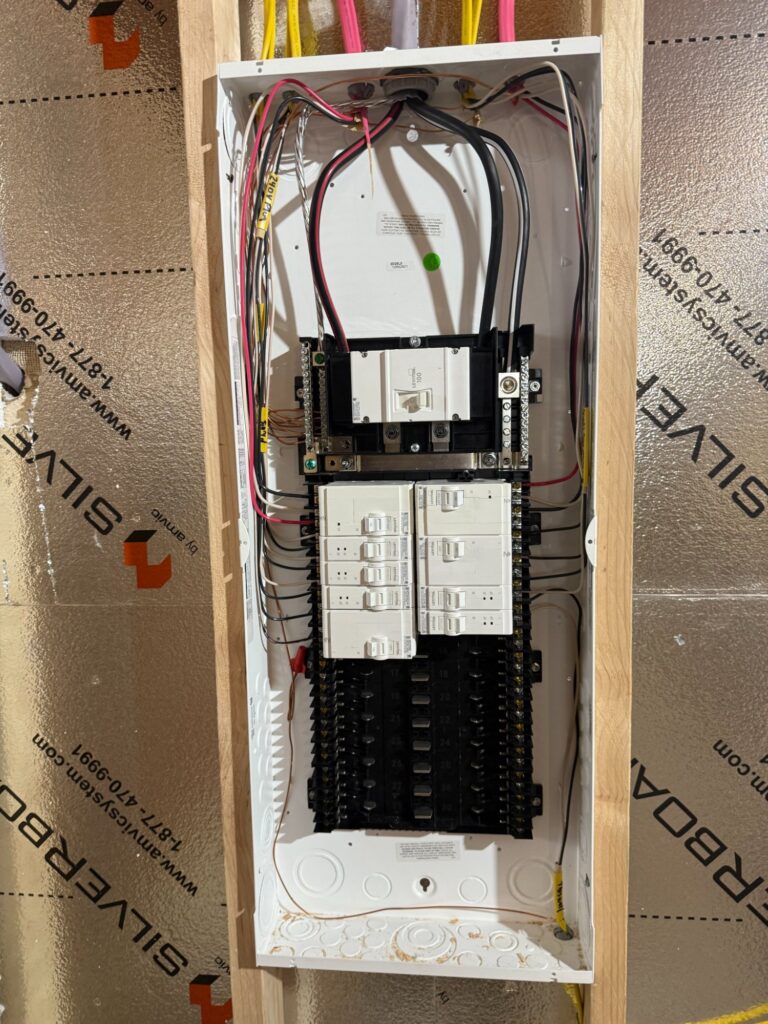 New panel installation open showing Leviton breakers and wiring in new construction