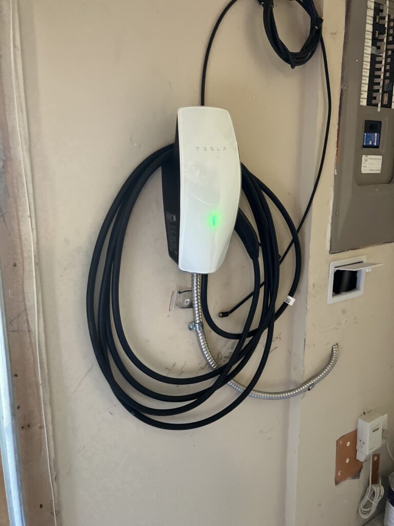 Hardwired EV charger installation in an Ashburn, VA garage — Tesla Wall Connector wired with MC cable by SparkWise Electric