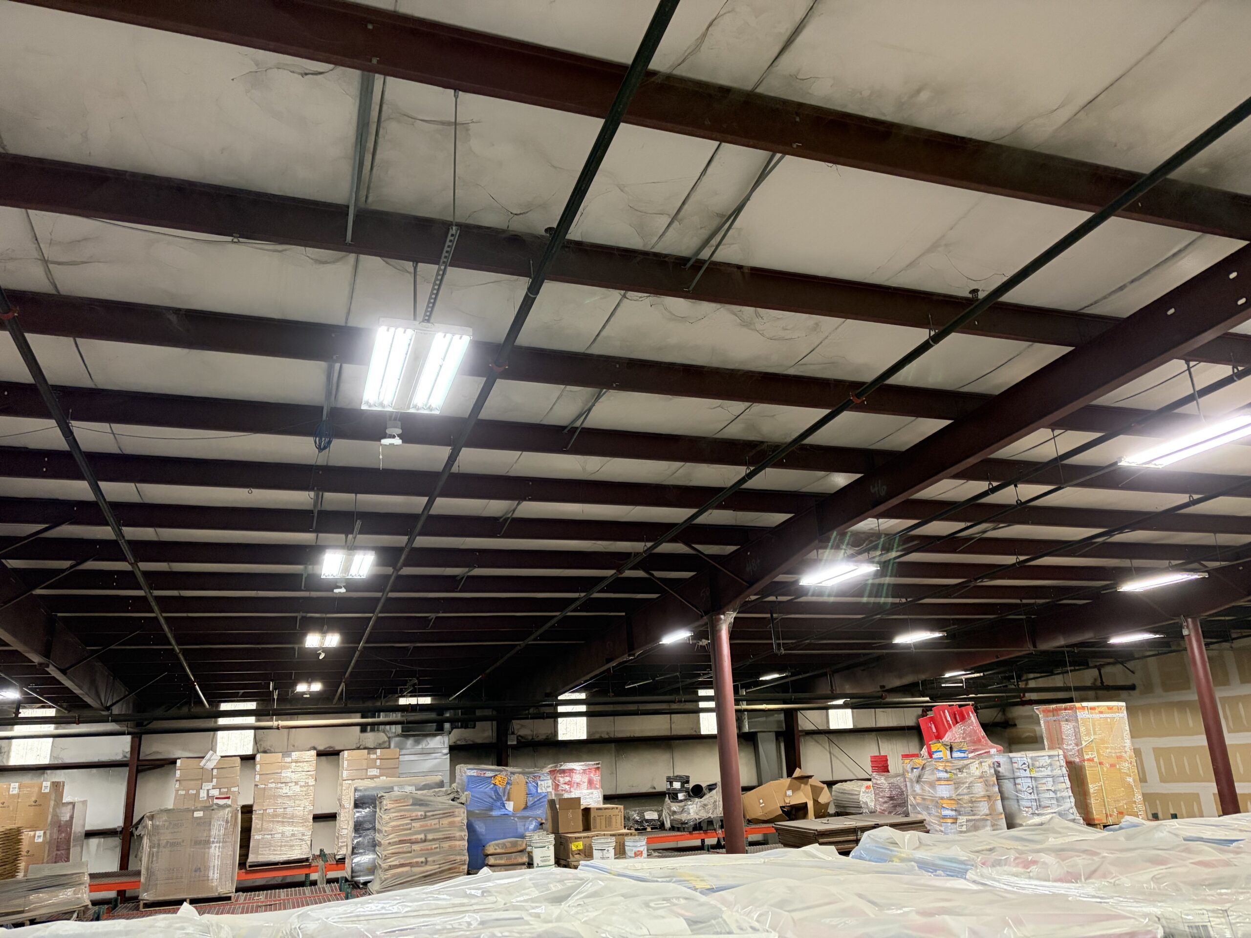 Wide view of warehouse ceiling LED lighting installed by SparkWise Electric