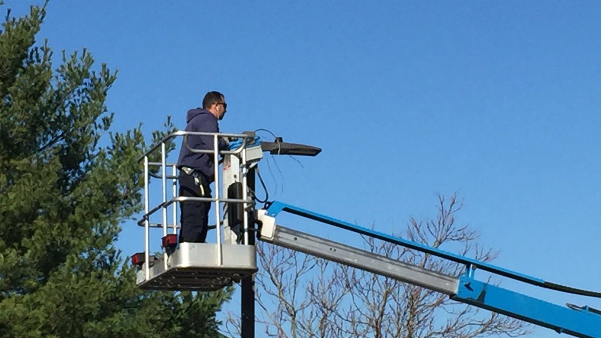 SparkWise electrician on boom lift performing commercial electrical work in Northern Virginia