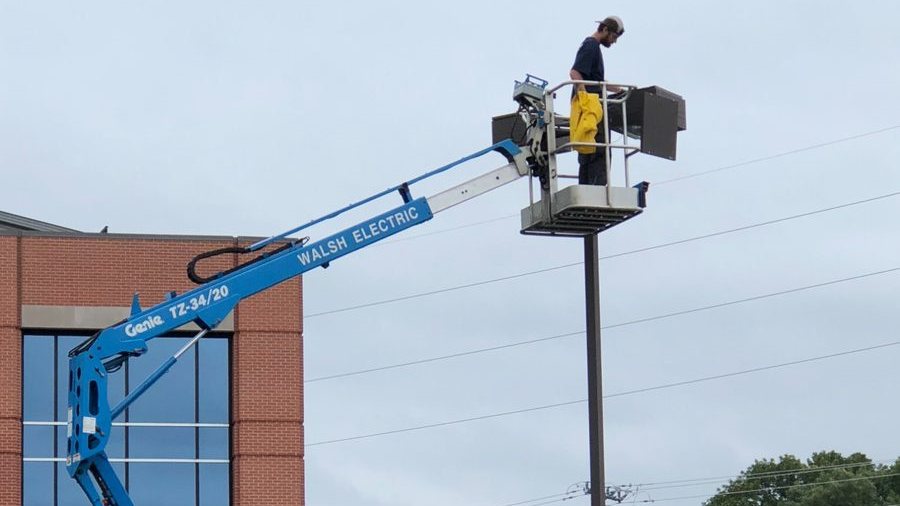 Commercial parking lot LED light installation with boom lift - SparkWise Electric Northern Virginia