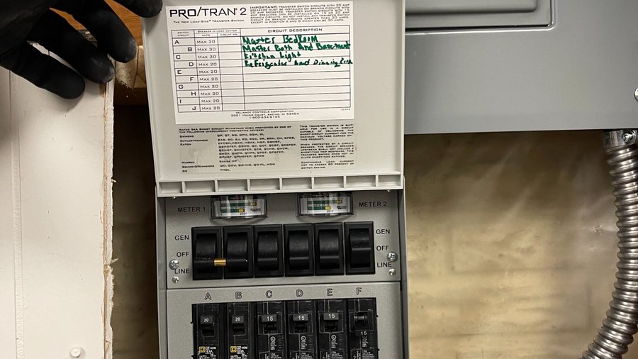 SparkWise electrician installing a Reliance Controls generator transfer switch
