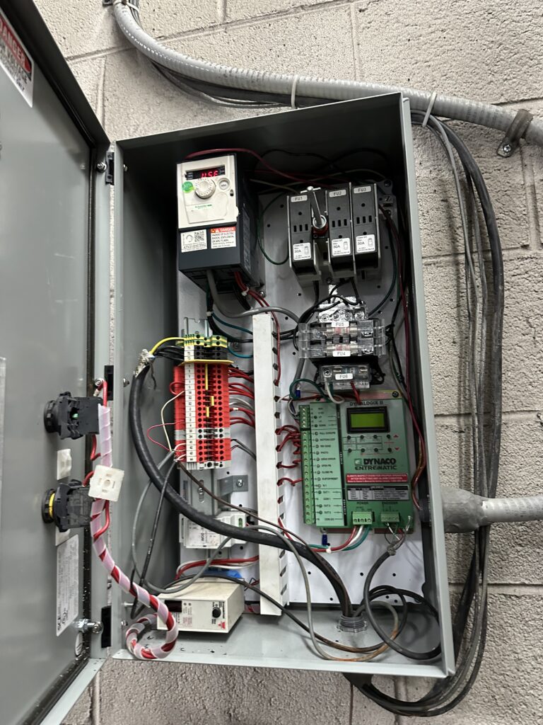 Commercial gate control panel interior with VFD and Dynaco Entrematic system — SparkWise Electric, Arlington VA