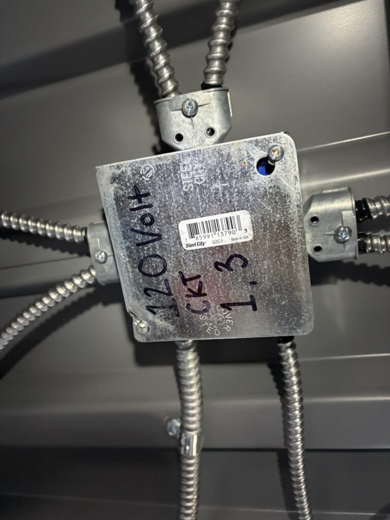 Labeled 120V circuit junction box with armored cable by SparkWise Electric in Washington DC