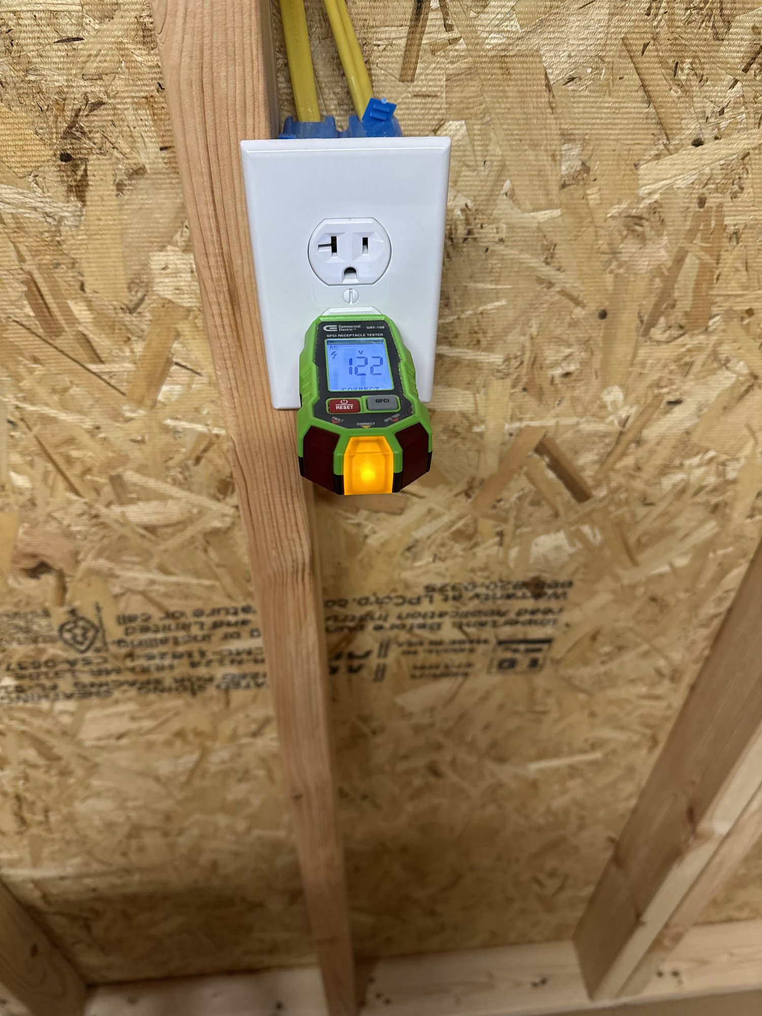 Receptacle tester confirming correct wiring and voltage at an outlet during electrical troubleshooting