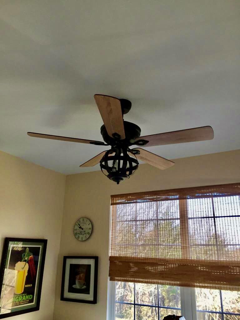 Wood-blade ceiling fan with cage light kit installed by SparkWise Electric in a Northern Virginia home
