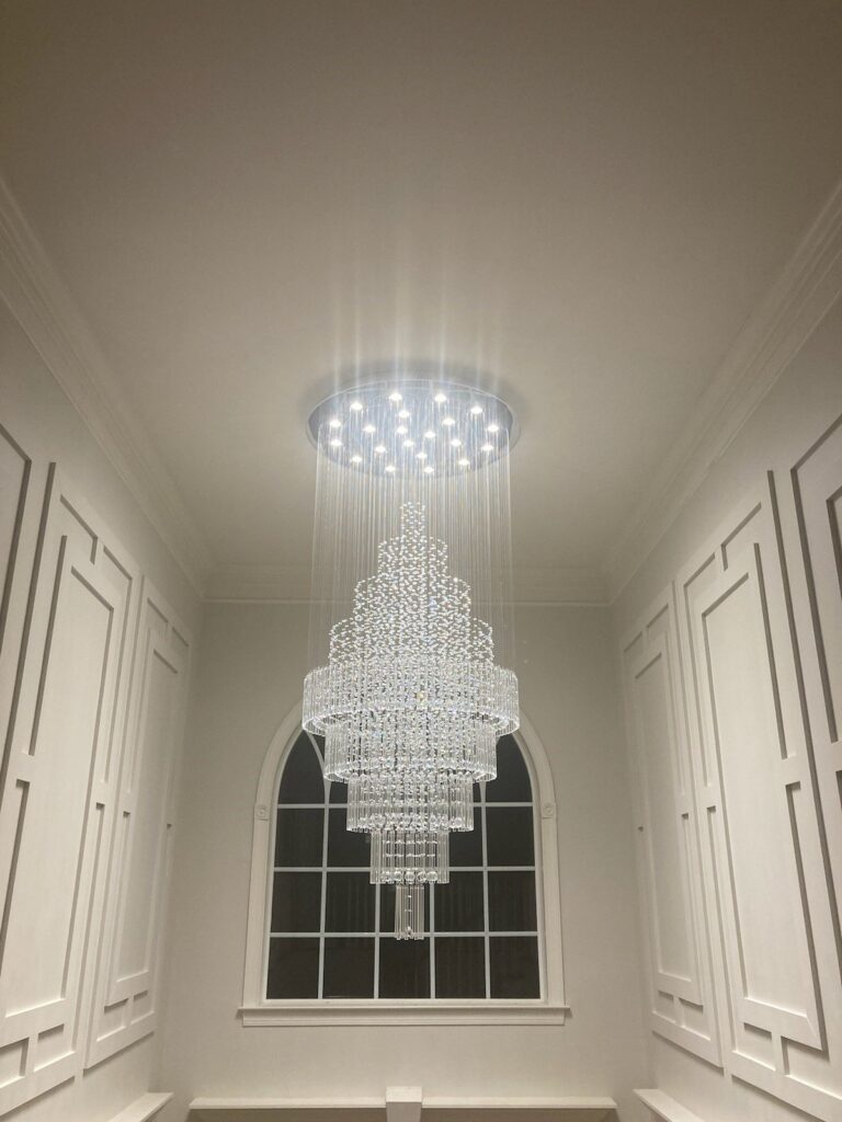 Crystal chandelier installed in a two-story foyer by SparkWise Electric in Northern Virginia