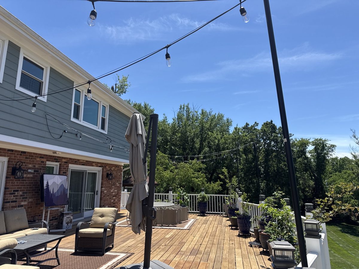 Outdoor deck string lighting on poles installed by SparkWise Electric
