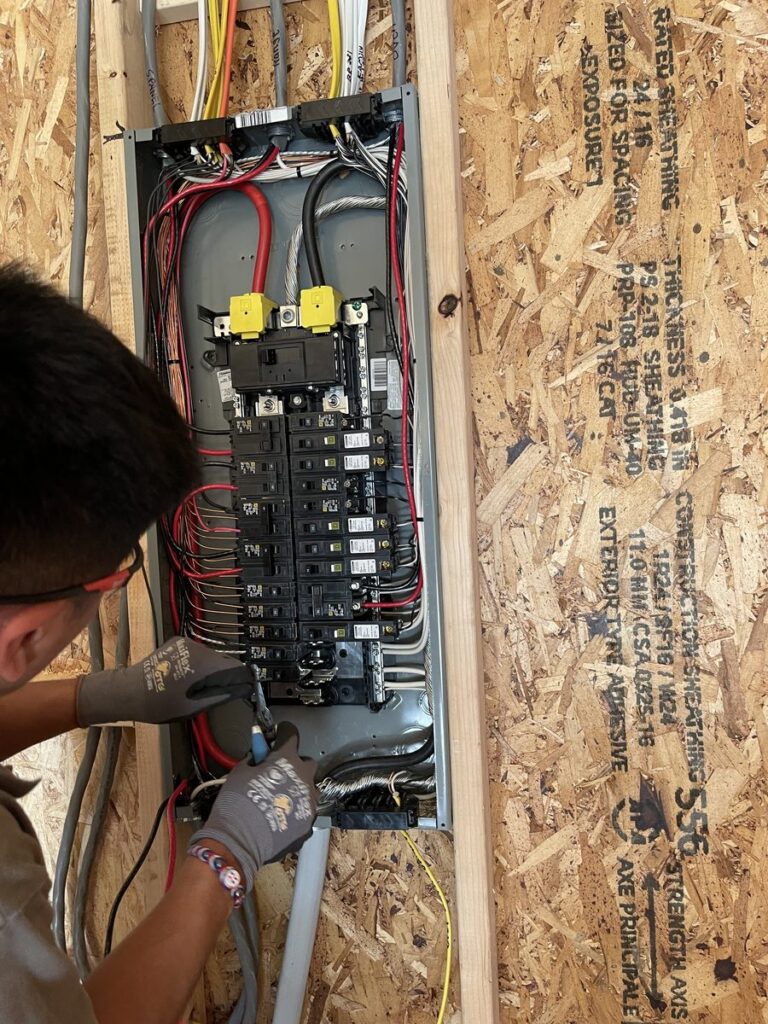 SparkWise Electric electrician installing a new electrical panel during a service upgrade