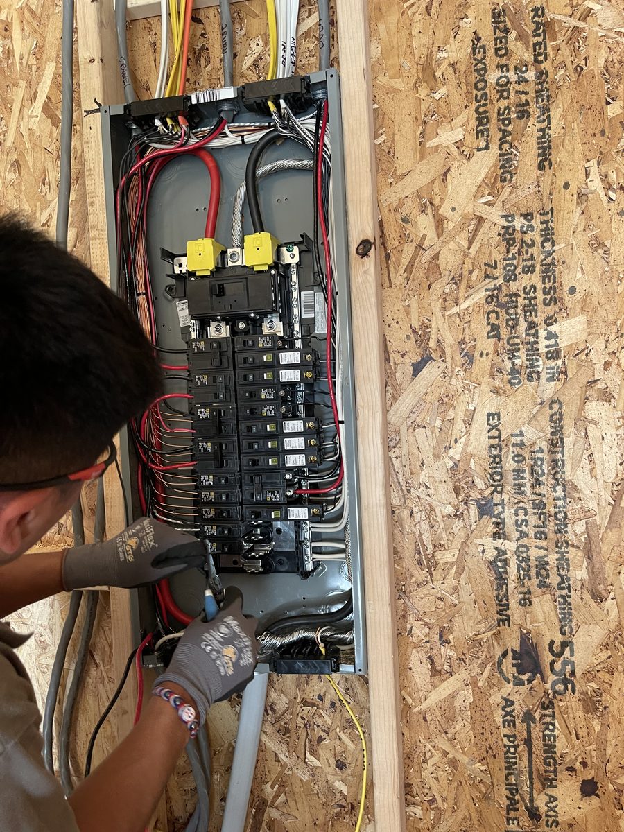 SparkWise Electric electrician installing a new electrical panel during a service upgrade