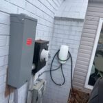 Emergency disconnect, meter, and Tesla Wall Connector installed by SparkWise Electric at a Fairfax VA home