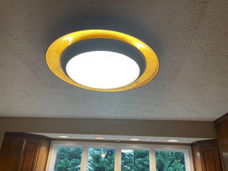 Flush-mount ceiling light fixture installed in a kitchen by SparkWise Electric