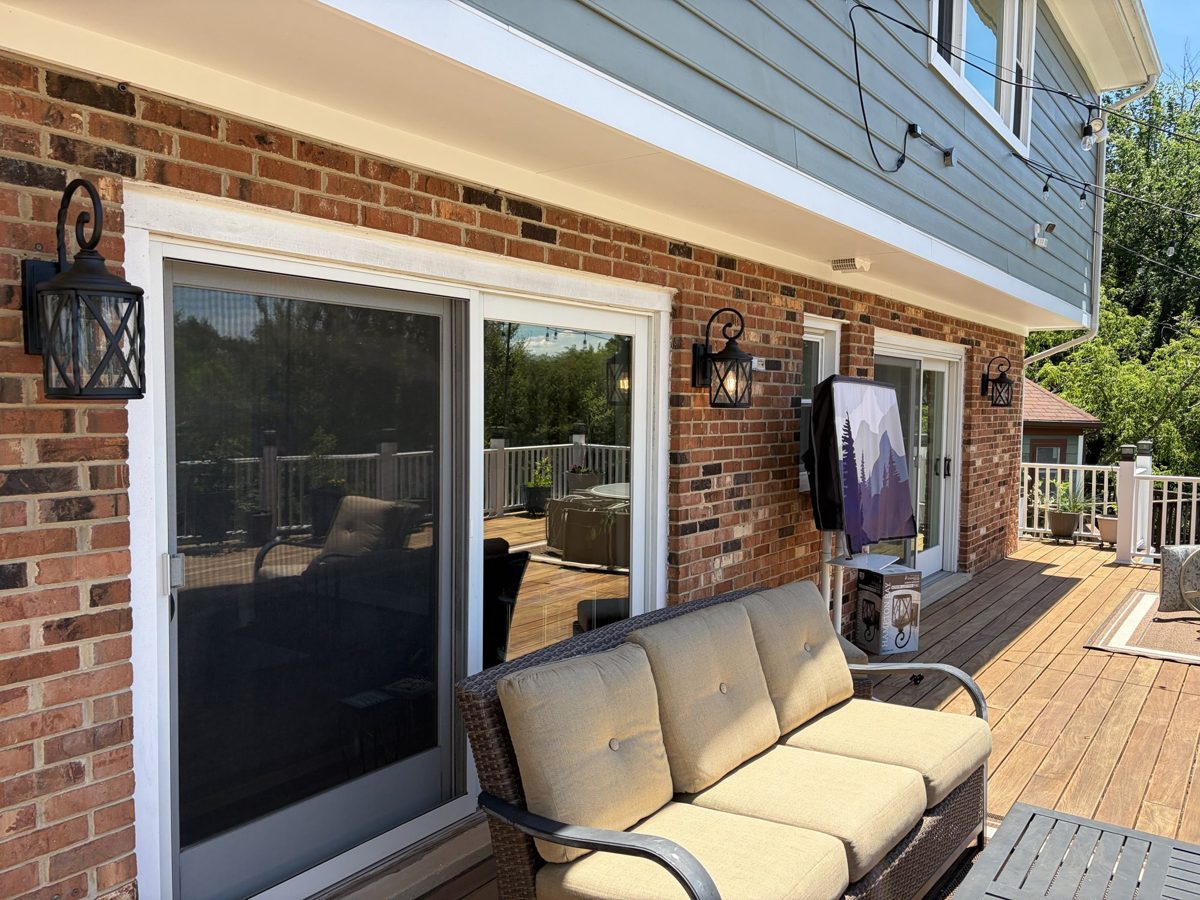 Outdoor wall sconce lighting installed on a deck by SparkWise Electric