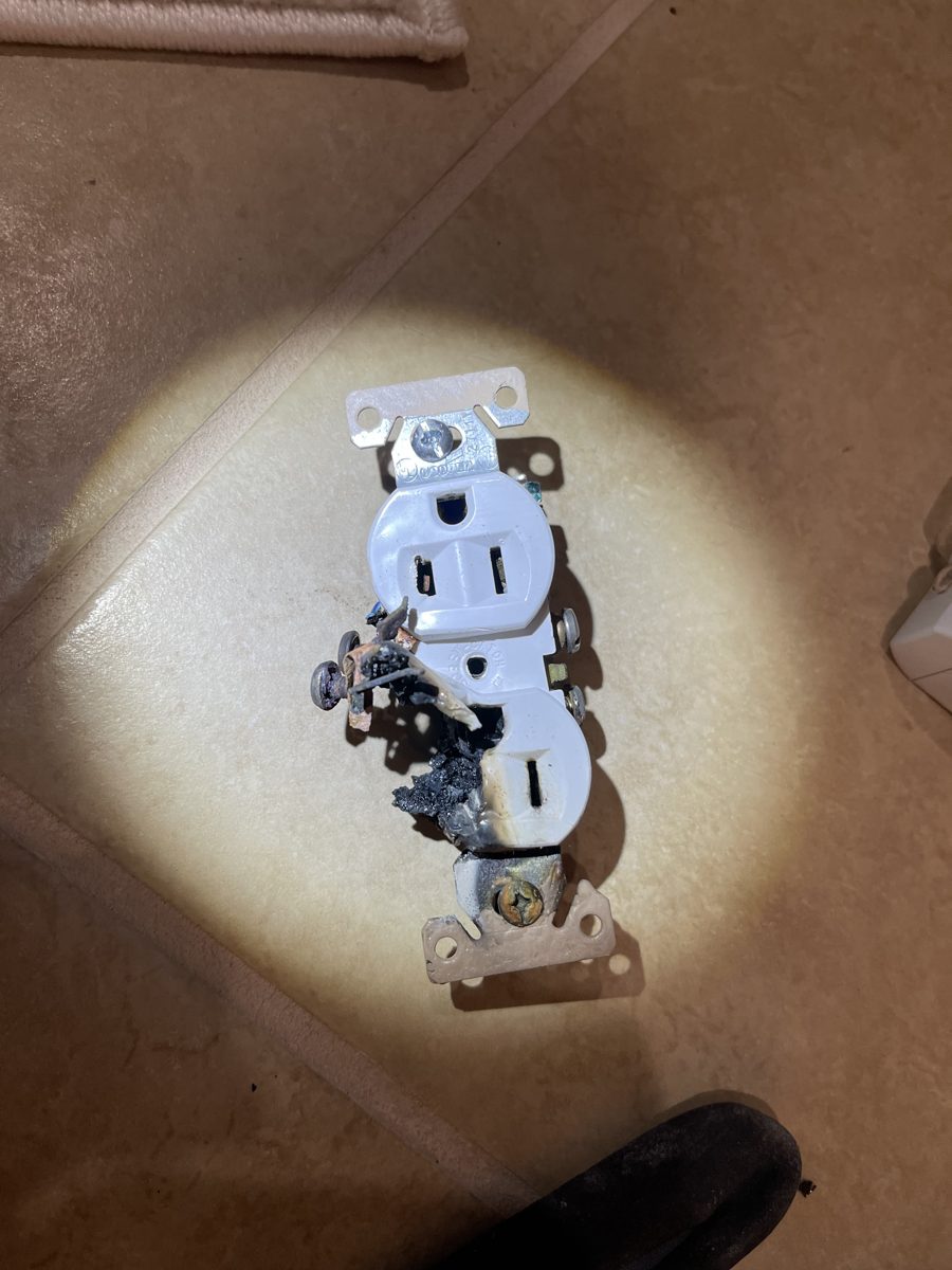 Residential receptacle showing heat damage after a space heater was run on an under-rated outlet