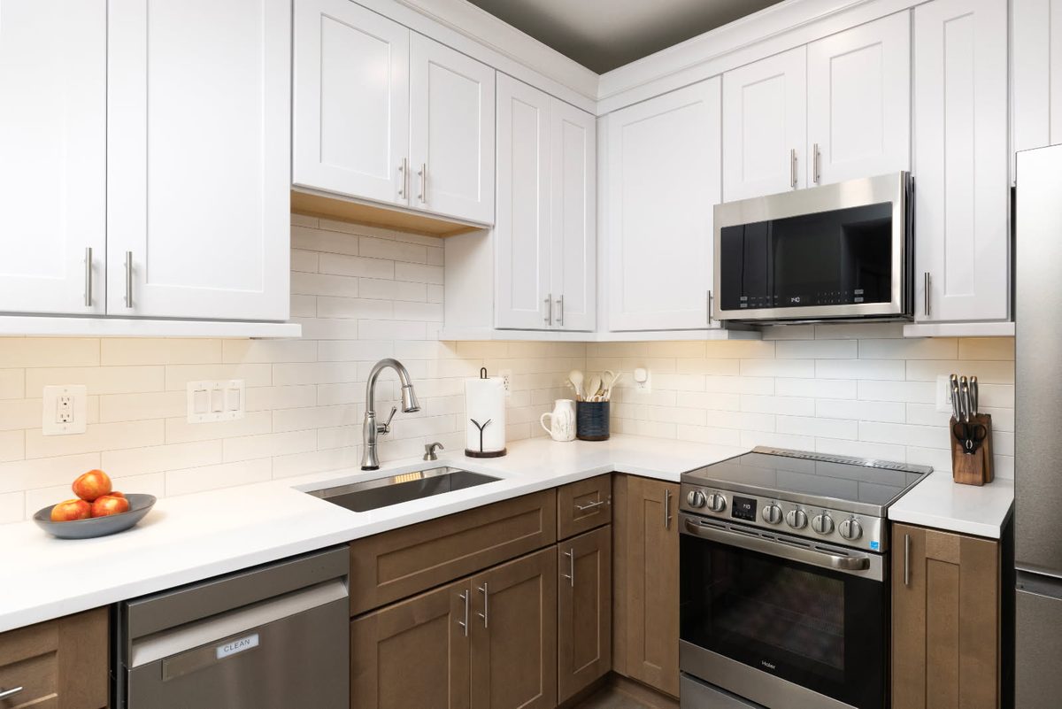 Under-cabinet lighting along a kitchen range wall installed by SparkWise Electric