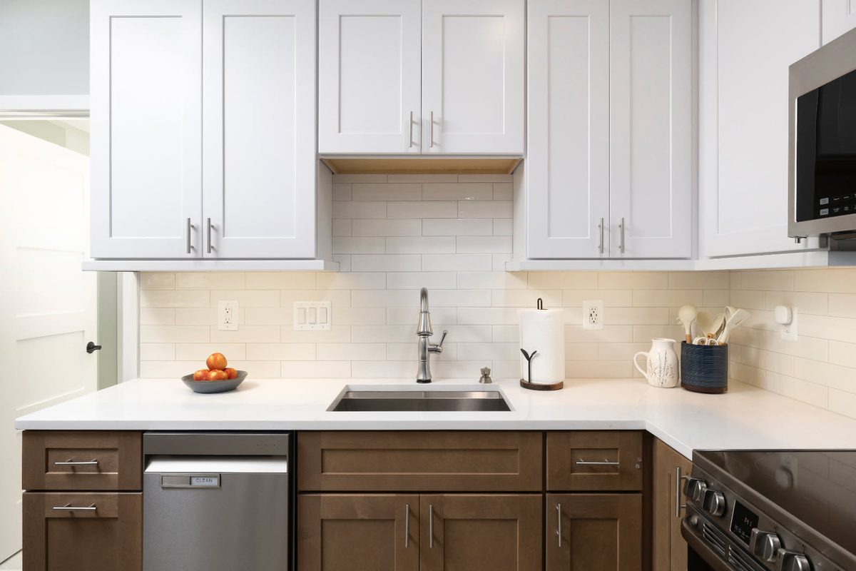 Under-cabinet lighting over a kitchen sink run installed by SparkWise Electric