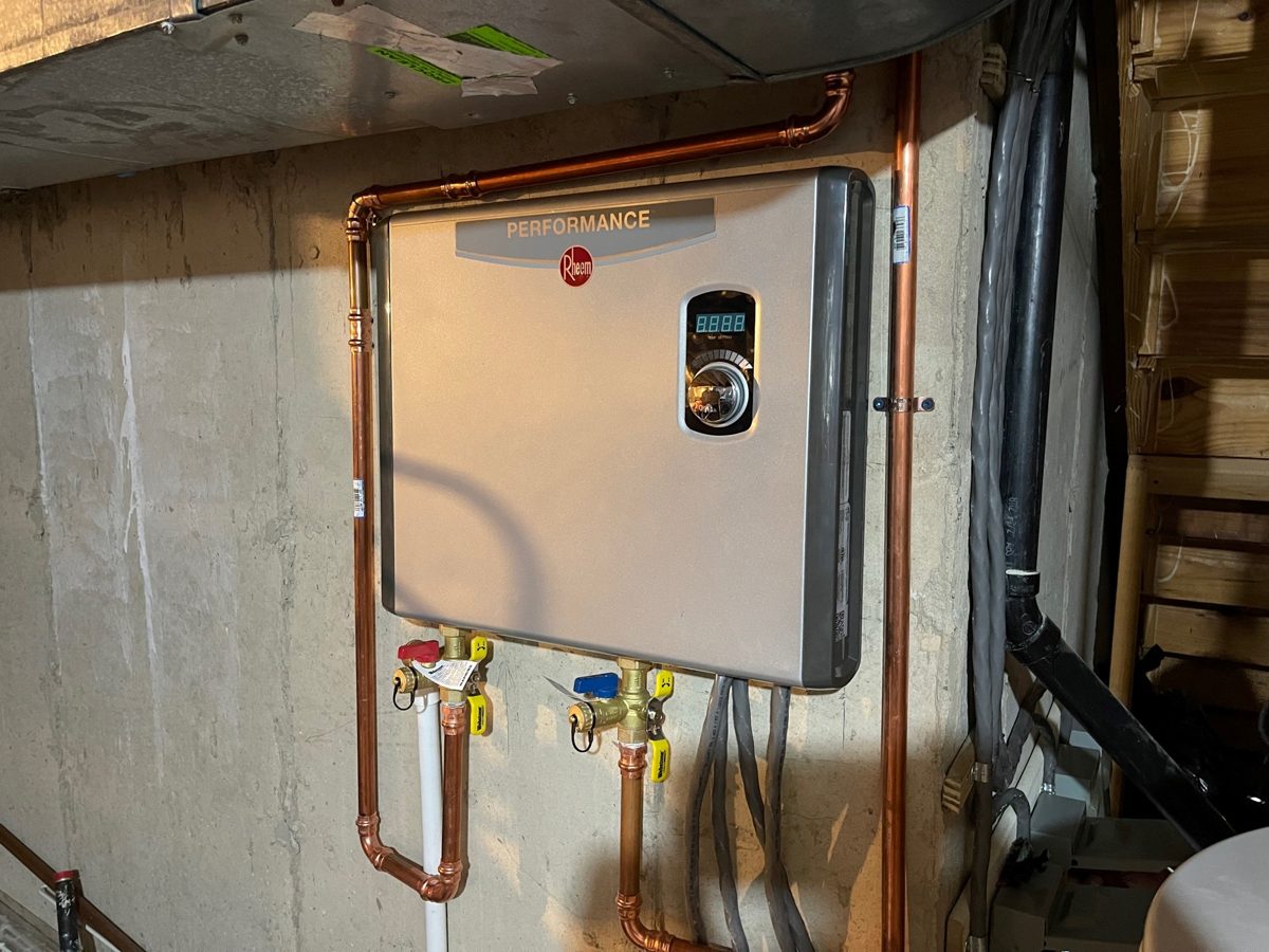 Rheem Performance electric tankless water heater installed in a Great Falls, VA basement with three separate branch circuits entering the unit – SparkWise Electric