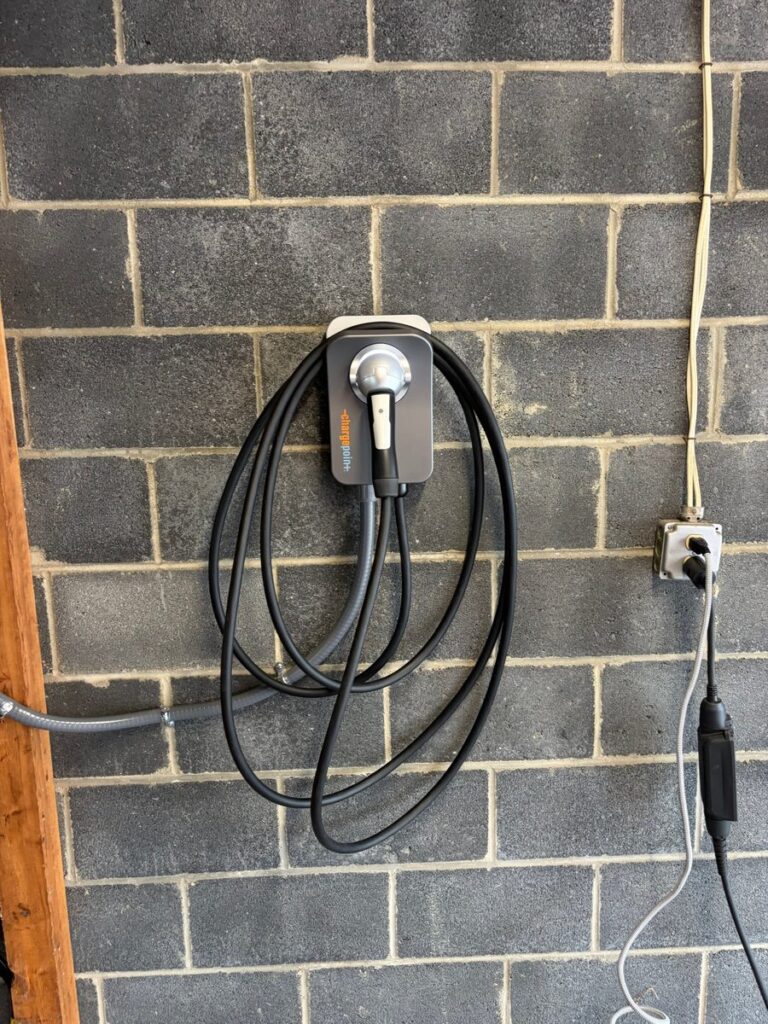 ChargePoint Home Flex EV charger hardwired on a block wall in a detached garage by SparkWise Electric in Petworth, Washington DC