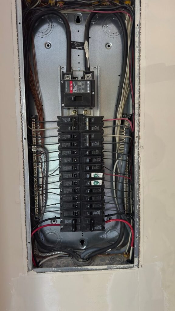 200 amp Eaton electrical panel with new 50 amp EV charger breaker landed by SparkWise Electric in a Petworth, Washington DC rowhome
